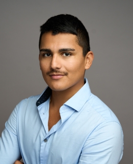 Man posing with arms crossed.